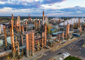 An expansive aerial shot of Pine Bend Oil Refinery in Rosemount, MN, showcasing industrial structures and pollution.