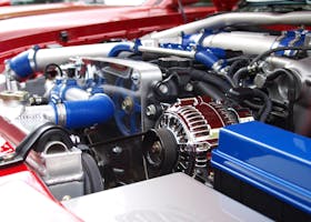 Detailed view of a clean modern car engine with vibrant colored components and sleek design.